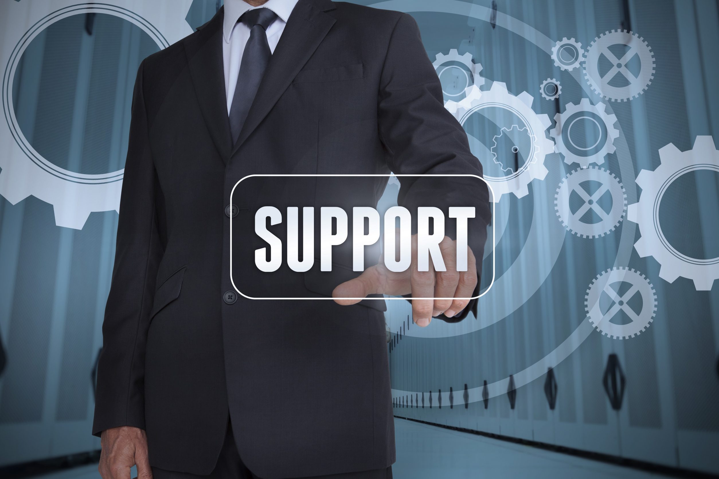Businessman selecting a label with support on it with gears on the background